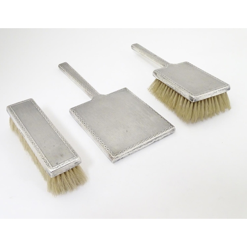 276 - Art Deco silver dressing table items with engine 
 turned decoration. Comprising two brushes and han... 