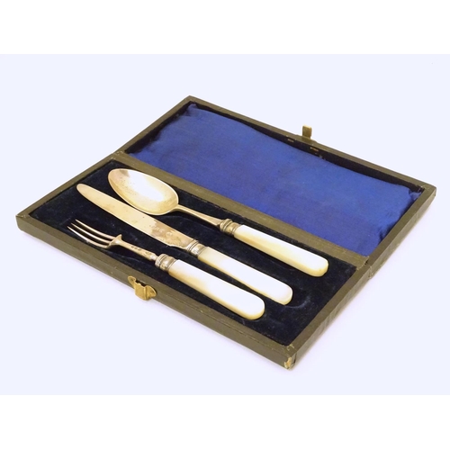 278 - A silver three piece christening set comprising knife, fork and spoon with mother of pearl handles. ... 