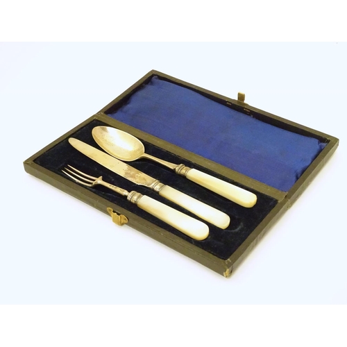 278 - A silver three piece christening set comprising knife, fork and spoon with mother of pearl handles. ... 