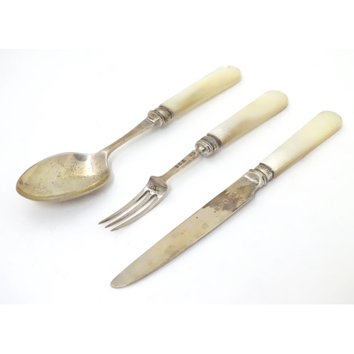 278 - A silver three piece christening set comprising knife, fork and spoon with mother of pearl handles. ... 