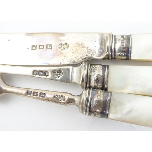 278 - A silver three piece christening set comprising knife, fork and spoon with mother of pearl handles. ... 