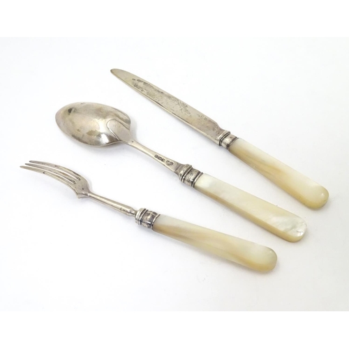 278 - A silver three piece christening set comprising knife, fork and spoon with mother of pearl handles. ... 