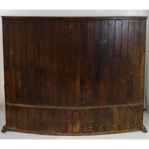 1562 - A 19thC tavern settle with an elm seat, planked bow back and shaped sides with scrolled armrests. 93... 