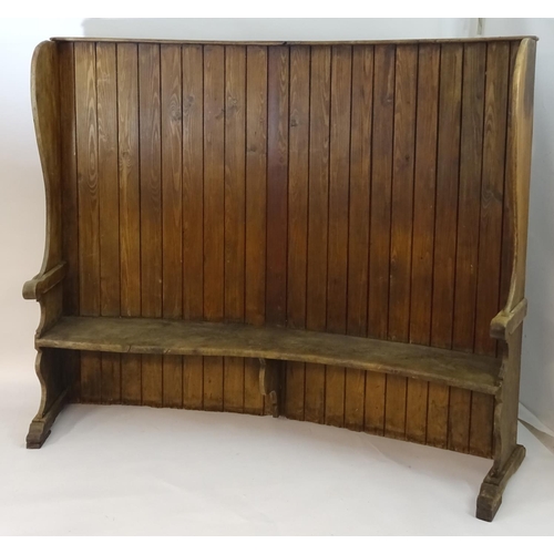 1562 - A 19thC tavern settle with an elm seat, planked bow back and shaped sides with scrolled armrests. 93... 