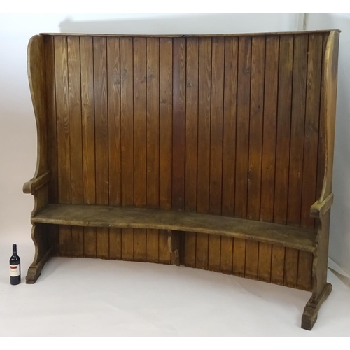 1562 - A 19thC tavern settle with an elm seat, planked bow back and shaped sides with scrolled armrests. 93... 