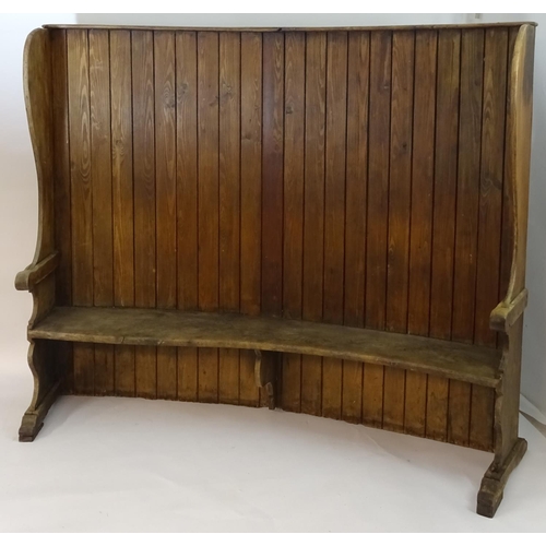 1562 - A 19thC tavern settle with an elm seat, planked bow back and shaped sides with scrolled armrests. 93... 