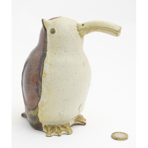 103 - A studio pottery model of a bird with an elongated beak. Impressed marks above feet. Approx. 6 1/4