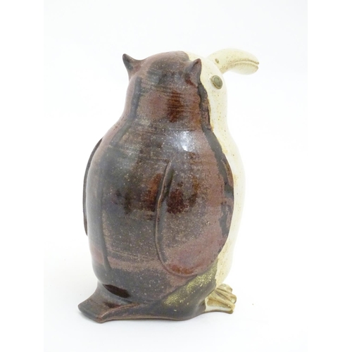 103 - A studio pottery model of a bird with an elongated beak. Impressed marks above feet. Approx. 6 1/4