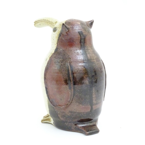 103 - A studio pottery model of a bird with an elongated beak. Impressed marks above feet. Approx. 6 1/4