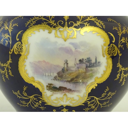 119 - A Coalport pot pourri with a cobalt blue ground with gilt detail and a central hand painted landscap... 