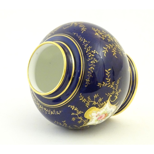 119 - A Coalport pot pourri with a cobalt blue ground with gilt detail and a central hand painted landscap... 