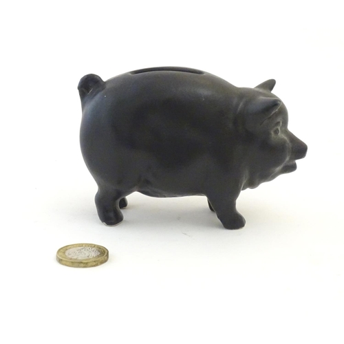 146 - A Sylvac matte black money / piggy bank modelled as a pot bellied pig, no. 1132. Approx. 3