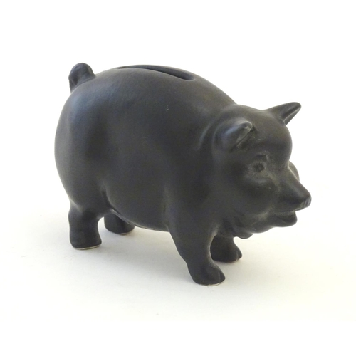 146 - A Sylvac matte black money / piggy bank modelled as a pot bellied pig, no. 1132. Approx. 3