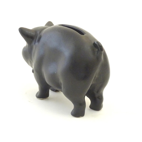 146 - A Sylvac matte black money / piggy bank modelled as a pot bellied pig, no. 1132. Approx. 3