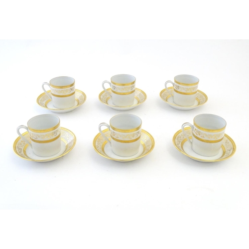 165 - A set of six Limoges coffee cups / cans and saucer with scrolling gilt decoration. Marked under. Cup... 