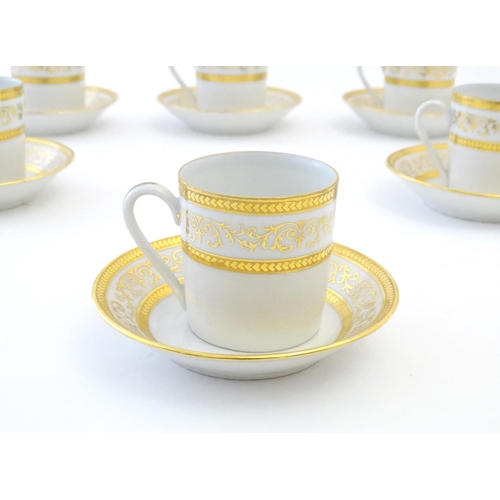 165 - A set of six Limoges coffee cups / cans and saucer with scrolling gilt decoration. Marked under. Cup... 