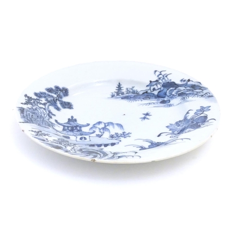 29 - A Chinese blue and white plate with a landscape scene with pagodas, flowers, etc. Approx. 9