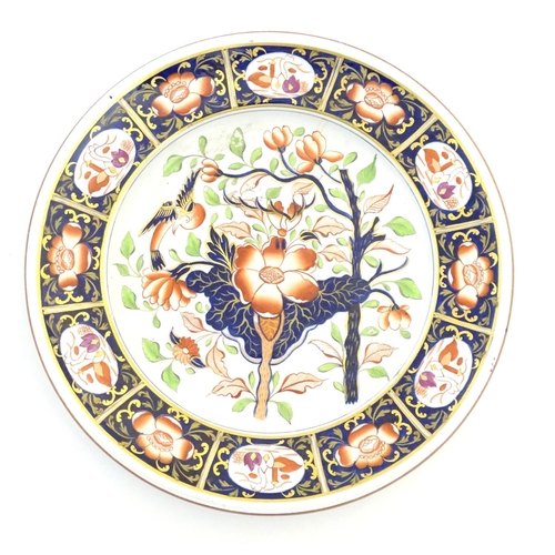 79 - A Copeland hand painted plate in the Imari palette with floral, foliate and bird detail with gilt hi... 