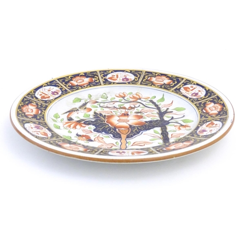 79 - A Copeland hand painted plate in the Imari palette with floral, foliate and bird detail with gilt hi... 