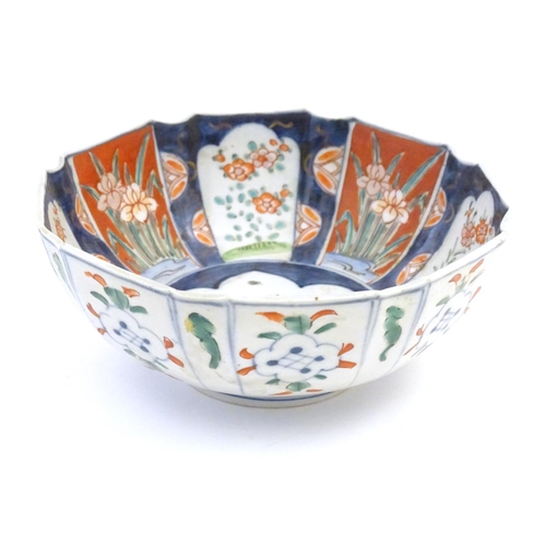 37 - A Japanese octagonal bowl in the Imari palette the centre decorated with ducks in a pond, the sides ... 