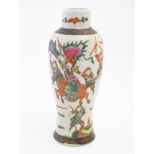 65 - A Japanese crackle glaze vase decorated in famille verte with warriors and horses. Character marks t... 