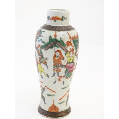 65 - A Japanese crackle glaze vase decorated in famille verte with warriors and horses. Character marks t... 