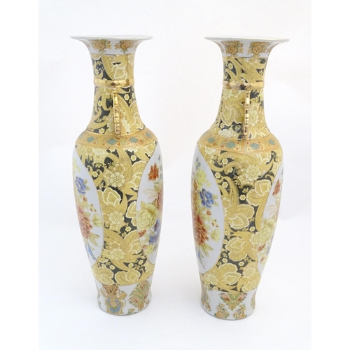 68 - A pair of large Oriental vases with twin handles of stylised form decorated with flowers and foliage... 