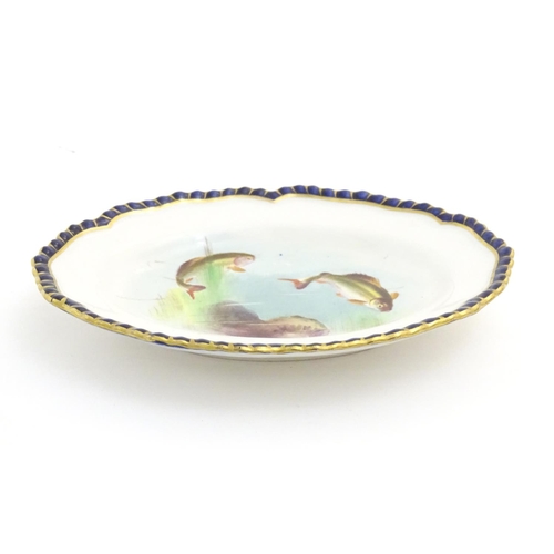 78 - A Royal Worcester dish of oval form with a lobed rim with fish detail. Marked under. Approx. 5 1/4