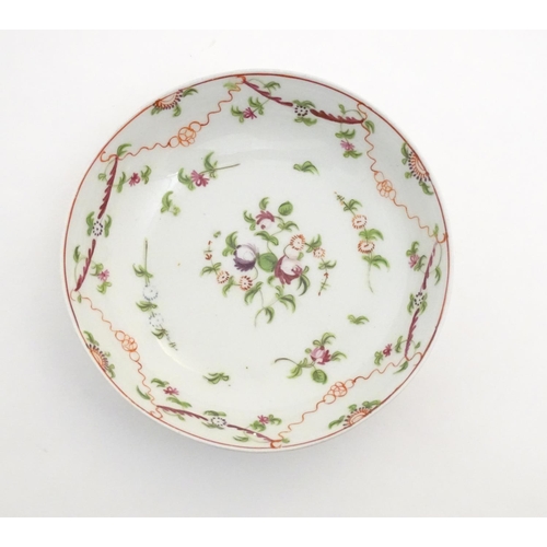 87 - A 19thC New Hall tea bowl and saucer with floral decoration, pattern no. 241. Tea bowl approx. 2