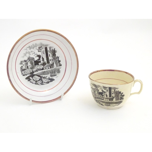 90 - A 19thC tea cup and saucer with monochrome transfer decoration depicting a river landscape with a sh... 