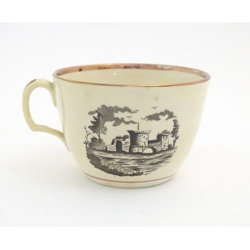 90 - A 19thC tea cup and saucer with monochrome transfer decoration depicting a river landscape with a sh... 