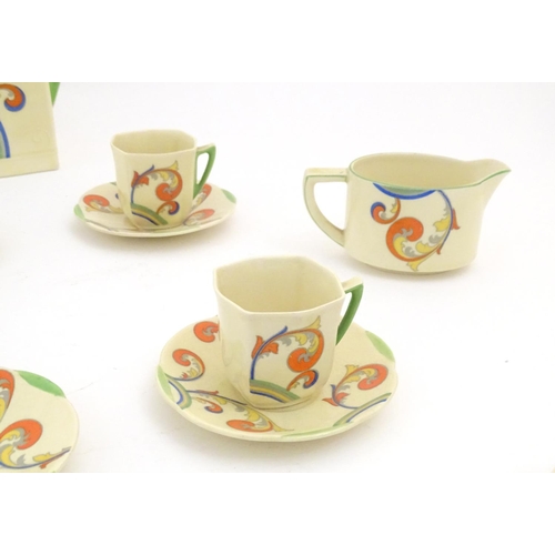 91 - A Royal Doulton Art Deco coffee set in the pattern Syren with scrolling foliate detail, comprising a... 