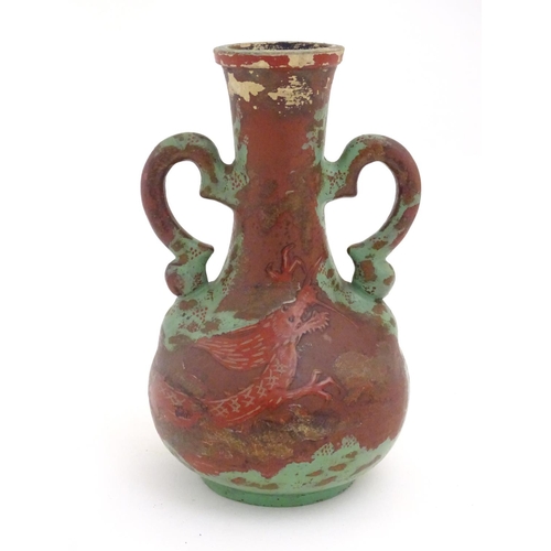 98 - A late 19th / early 20thC bottle vase with shaped twin handles, and dragon decoration. Approx. 9