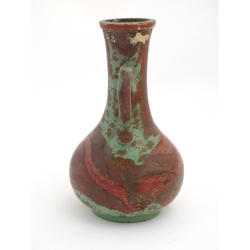 98 - A late 19th / early 20thC bottle vase with shaped twin handles, and dragon decoration. Approx. 9