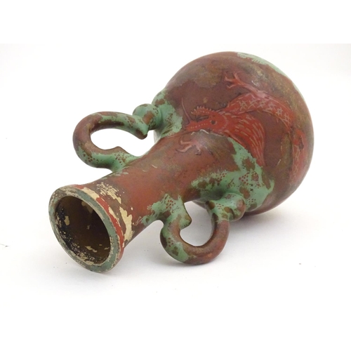 98 - A late 19th / early 20thC bottle vase with shaped twin handles, and dragon decoration. Approx. 9