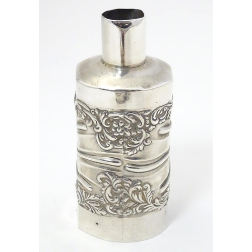 301 - A silver bottle cover with embossed detail, hallmarked London 1901 maker Goldsmiths & Silversmiths C... 