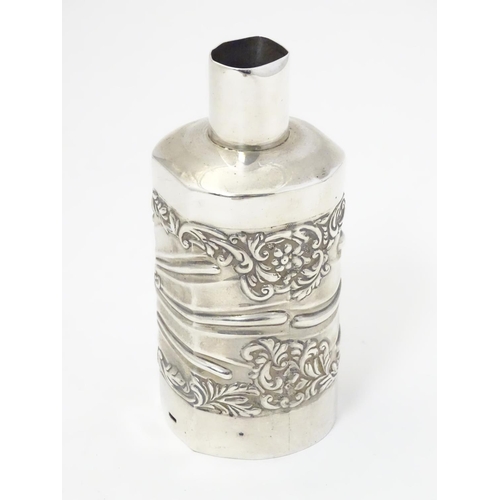 301 - A silver bottle cover with embossed detail, hallmarked London 1901 maker Goldsmiths & Silversmiths C... 