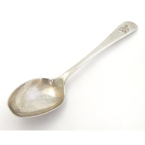 304 - A silver teaspoon with engraved decoration to handle depicting a figure playing bowls. Hallmarked  S... 