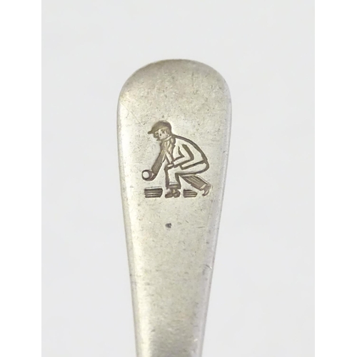 304 - A silver teaspoon with engraved decoration to handle depicting a figure playing bowls. Hallmarked  S... 