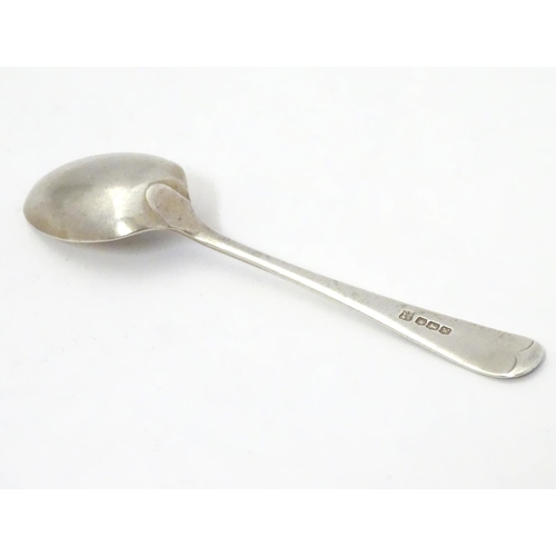 304 - A silver teaspoon with engraved decoration to handle depicting a figure playing bowls. Hallmarked  S... 