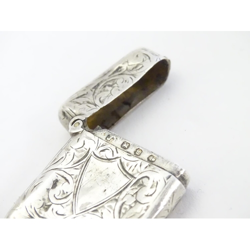 323 - A silver vesta case with engraved decoration. Hallmarked Birmingham 1896 maker JT. 1 1/2