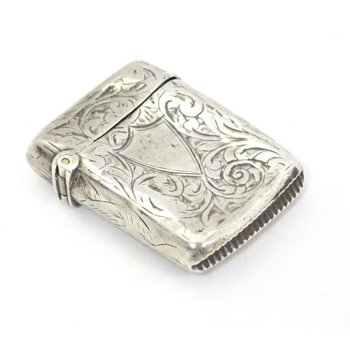 323 - A silver vesta case with engraved decoration. Hallmarked Birmingham 1896 maker JT. 1 1/2