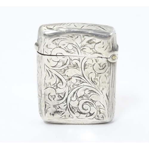 323 - A silver vesta case with engraved decoration. Hallmarked Birmingham 1896 maker JT. 1 1/2