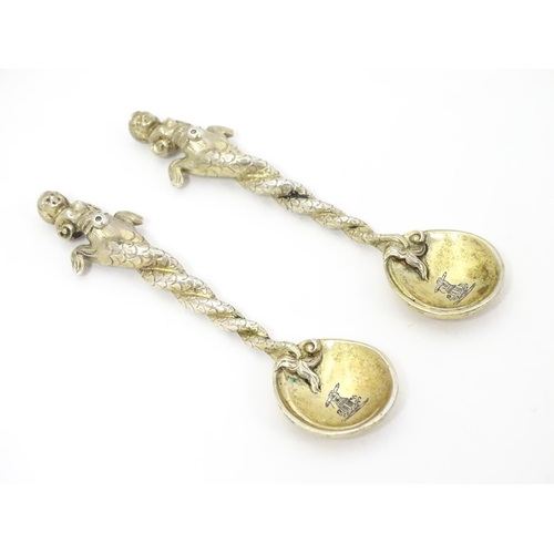 327 - An unusual pair of gilded white metal salt spoons, the bowls with crescent decoration and engraved a... 