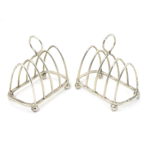 343 - A pair toast racks of 5 -bar arched form. Hallmarked London 1931 maker Harrods Ltd. 3