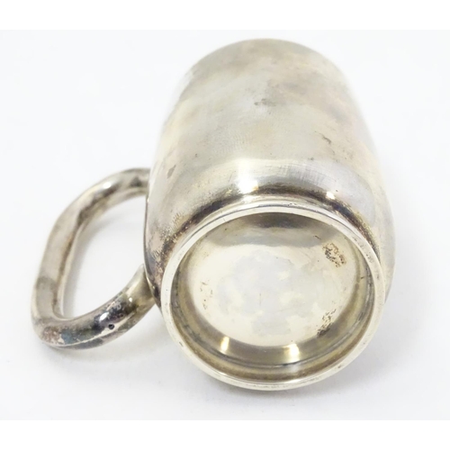 353 - A silver christening mug with loop handle. Hallmarked Birmingham 1918 maker Wilmot Manufacturing Co.... 