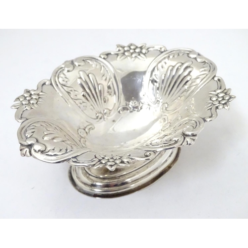 362 - A silver bonbon dish with C-scroll and foliate decoration raised on oval stepped base. Hallmarked Lo... 