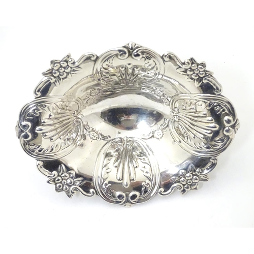 362 - A silver bonbon dish with C-scroll and foliate decoration raised on oval stepped base. Hallmarked Lo... 