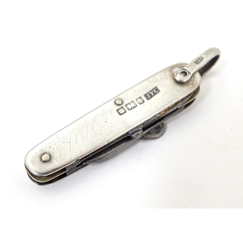 363 - A silver handled pocket knife with folding knife, scissors and button hook sections Hallmarked Sheff... 