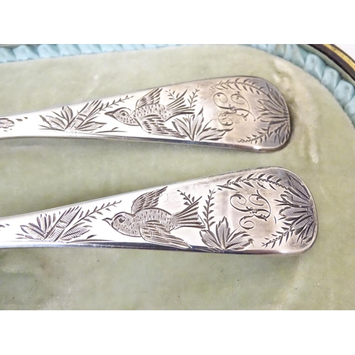 366 - A pair of white metal serving spoons with Aesthetic Movement birds amongst foliage decoration and ha... 